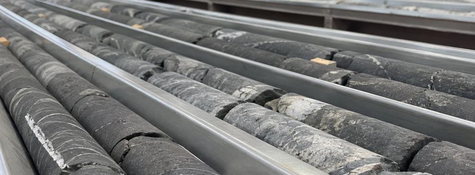 Drill core. Illustrative editorial image; no real project or company is depicted.